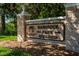 Stone entrance sign for Hammock Park, surrounded by lush greenery and trees at 621 Duchess Blvd, Dunedin, FL 34698