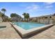 Community pool with a spacious deck, lounge chairs, and well-maintained landscaping at 621 Duchess Blvd, Dunedin, FL 34698