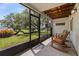 Relaxing screened porch with wood ceiling and a view of the beautifully landscaped backyard at 621 Duchess Blvd, Dunedin, FL 34698