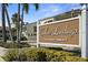 Waterfront community sign, Curlew Landings, with tropical landscaping and well-maintained grounds at 621 Duchess Blvd, Dunedin, FL 34698