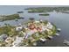 Aerial of house surrounded by water with boat dock and boat lift at 633 Soundview Dr, Palm Harbor, FL 34683
