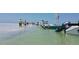 A crowd enjoys a sunny day on a sandbar with boats and shallow water at 633 Soundview Dr, Palm Harbor, FL 34683