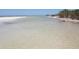 Tranquil beach scene with clear, shallow water and white sand at 633 Soundview Dr, Palm Harbor, FL 34683