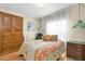 Cozy bedroom with vintage decor, hardwood floors, and plenty of storage space at 633 Soundview Dr, Palm Harbor, FL 34683
