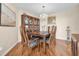 Formal dining room featuring a chandelier, hardwood floors, and a large display cabinet at 633 Soundview Dr, Palm Harbor, FL 34683