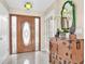 Inviting entryway with a wooden front door, tile flooring, and decorative accents at 633 Soundview Dr, Palm Harbor, FL 34683