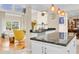 The kitchen has dark counters with white cabinets and views of the living room at 633 Soundview Dr, Palm Harbor, FL 34683
