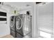 Functional laundry area with front loading washer and dryer at 633 Soundview Dr, Palm Harbor, FL 34683
