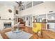Bright living room featuring a stone fireplace, hardwood floors, and an open floor plan leading to the kitchen at 633 Soundview Dr, Palm Harbor, FL 34683