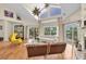 Spacious living room with hardwood floors, high ceilings, and sliding doors to the outdoor deck at 633 Soundview Dr, Palm Harbor, FL 34683