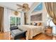 Serene main bedroom with a large window, hardwood floors, and elegant decor at 633 Soundview Dr, Palm Harbor, FL 34683