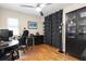 Home office with hardwood floors, ceiling fan, and black shelving at 633 Soundview Dr, Palm Harbor, FL 34683
