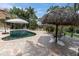 Private backyard oasis with refreshing pool, cabana, patio, and inviting outdoor dining area at 633 Soundview Dr, Palm Harbor, FL 34683