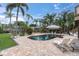 A serene backyard with a private pool, lounge chairs, and lush greenery at 633 Soundview Dr, Palm Harbor, FL 34683