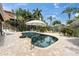 Private backyard pool surrounded by brick pavers, patio furniture, and mature landscaping at 633 Soundview Dr, Palm Harbor, FL 34683