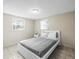 This cozy bedroom offers a minimalistic bed frame and two sunlit windows for natural lighting at 6627 Main St, New Port Richey, FL 34653