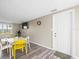Bright dining room features a modern table set, laminate flooring, and an adjacent wall-mounted television at 6627 Main St, New Port Richey, FL 34653