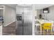 Open-concept kitchen featuring stainless steel refrigerator and views into the dining room at 6627 Main St, New Port Richey, FL 34653
