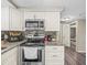 The updated kitchen has granite countertops, modern stainless steel appliances, and mosaic tile backsplash at 6627 Main St, New Port Richey, FL 34653