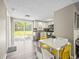Modern kitchen and dining area with stainless steel appliances, ample cabinet space, and backyard access at 6627 Main St, New Port Richey, FL 34653
