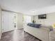 Bright and open living room with wood-look floors and natural light streaming through the windows at 6627 Main St, New Port Richey, FL 34653