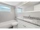 Bright bathroom with updated vanity, granite countertop, and white tiled shower over tub at 7926 Gulf Way, Hudson, FL 34667