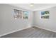 Bright bedroom with modern floors and two large windows offering ample natural light at 7926 Gulf Way, Hudson, FL 34667