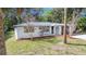 Home featuring a freshly painted exterior, manicured landscaping, and an attached one-car garage with an arched entryway at 7926 Gulf Way, Hudson, FL 34667