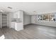 Bright kitchen featuring white cabinets, granite countertops, subway tile backsplash, and stainless steel sink adjacent to dining space at 7926 Gulf Way, Hudson, FL 34667