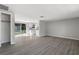 Open-concept living room with modern flooring, sliding glass doors and kitchen view at 7926 Gulf Way, Hudson, FL 34667