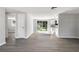 Open-concept living space with new flooring, slider to backyard and bright kitchen at 7926 Gulf Way, Hudson, FL 34667