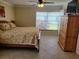Bright bedroom with a ceiling fan, window with blinds and wardrobe next to the bed at 9035 37Th N St, Pinellas Park, FL 33782