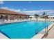 Sparkling community pool featuring accessible entry, lounge chairs, and clubhouse views at 9035 37Th N St, Pinellas Park, FL 33782