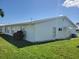 Exterior view of a well-maintained home surrounded by a green lawn under a sunny sky at 9035 37Th N St, Pinellas Park, FL 33782