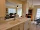Modern kitchen featuring white cabinets, quartz countertops, stainless steel appliances, and breakfast bar at 9035 37Th N St, Pinellas Park, FL 33782