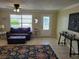 Inviting living room area with neutral decor, a comfortable sofa, and a view of the front door at 9035 37Th N St, Pinellas Park, FL 33782