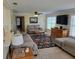 Cozy living room featuring neutral walls, tile floors, a large rug, and a flat screen television at 9035 37Th N St, Pinellas Park, FL 33782
