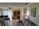Comfortable living area featuring a ceiling fan, desk, bookcase, and sliding glass doors to the outside at 9035 37Th N St, Pinellas Park, FL 33782