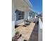 Cozy outdoor patio with tiled flooring, seating, and a small wall for added privacy at 9035 37Th N St, Pinellas Park, FL 33782