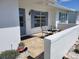 Charming front patio with tiled flooring, comfortable seating, and a decorative turtle planter at 9035 37Th N St, Pinellas Park, FL 33782