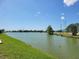 Expansive pond view with lush green banks and a clear blue sky at 9035 37Th N St, Pinellas Park, FL 33782