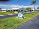 Community street view showcasing homes, green lawns, landscaping, and neighborhood signage at 9035 37Th N St, Pinellas Park, FL 33782