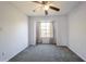 Cozy bedroom featuring a neutral carpet, window with curtains, and light violet colored walls at 9100 Dr Martin Luther King Jr N St # 1204, St Petersburg, FL 33702