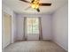Bedroom with carpet flooring and view into the backyard through the large window at 9100 Dr Martin Luther King Jr N St # 1204, St Petersburg, FL 33702
