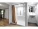 This bathroom features a shower, sink, and a view into the living area at 9132 Mango St, New Port Richey, FL 34654
