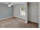 Comfortable bedroom features a ceiling fan, window, and closet, providing essential amenities at 9132 Mango St, New Port Richey, FL 34654