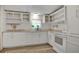 Bright kitchen features white cabinetry, modern appliances, and updated countertops perfect for cooking and entertaining at 9132 Mango St, New Port Richey, FL 34654