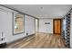 Bright living room featuring stylish floors and wood door at 9132 Mango St, New Port Richey, FL 34654