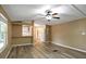 Open-concept living room featuring wood-look floors and a pass-through to the kitchen with white appliances at 9132 Mango St, New Port Richey, FL 34654
