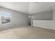 Upstairs bonus room with neutral walls and carpet, and a window with blinds at 9818 White Barn Way, Riverview, FL 33569